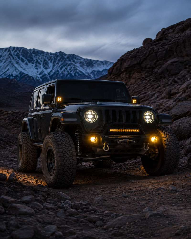 Jeep Wrangler off-road LED fog lights and headlights on a rocky mountain trail