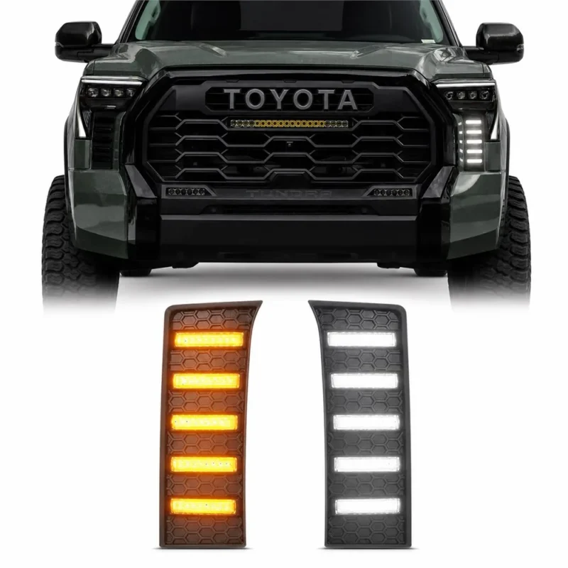Pair of black honeycomb Tundra vent panels shown in amber and white below the front of a modified Toyota Tundra