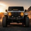 Jeep Wrangler JL headlights amber turn signal illuminated at golden hour sunset