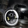 close-up of 7 inch jeep wrangler halo led headlights with white DRL on off-road background