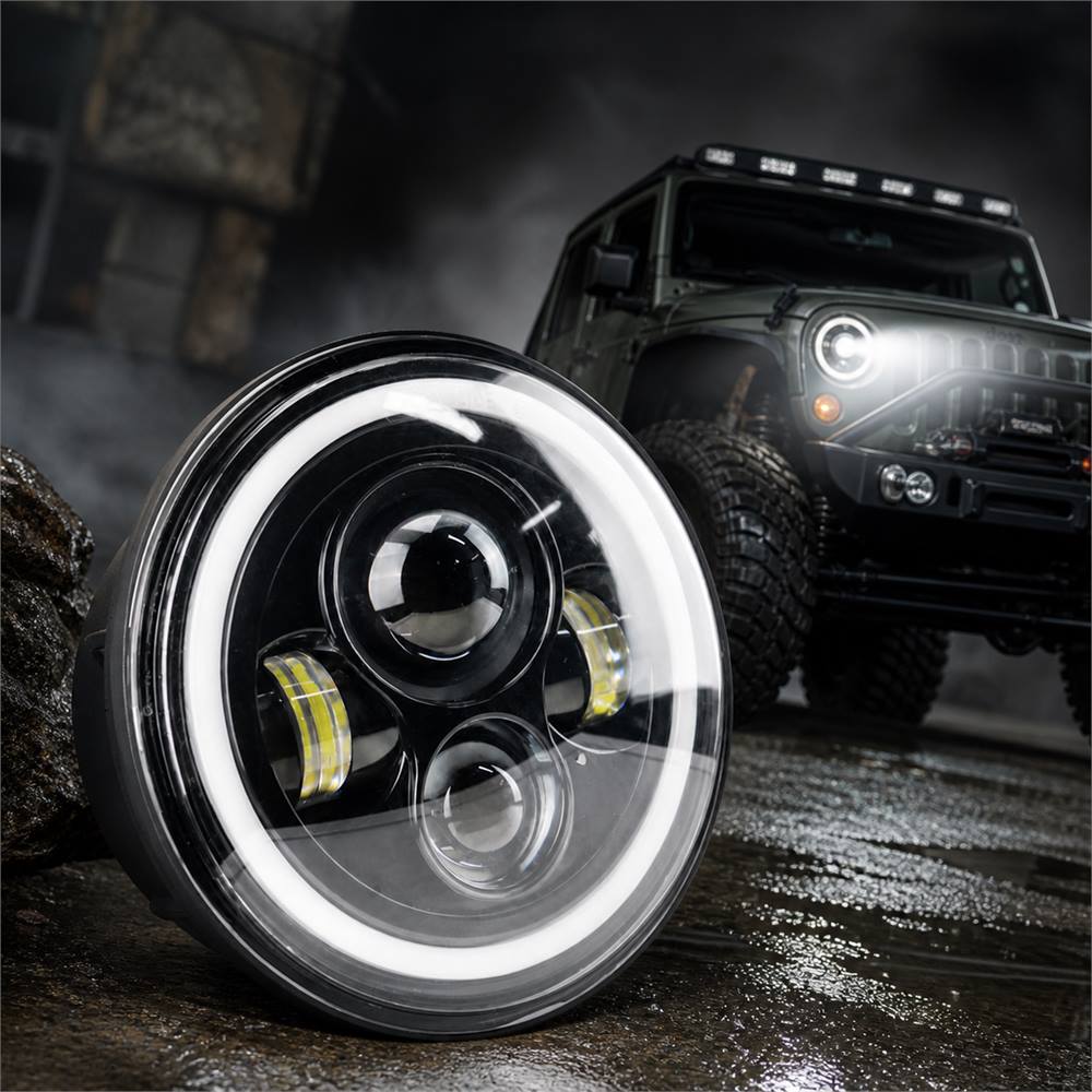 close-up of 7 inch jeep wrangler halo led headlights with white DRL on off-road background