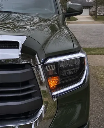Customer review photo of a Toyota Tacoma with upgraded LED headlight in a suburban driveway