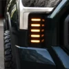 Close-up of five amber LED bars illuminated inside the black honeycomb vent panel beside a Tundra headlight