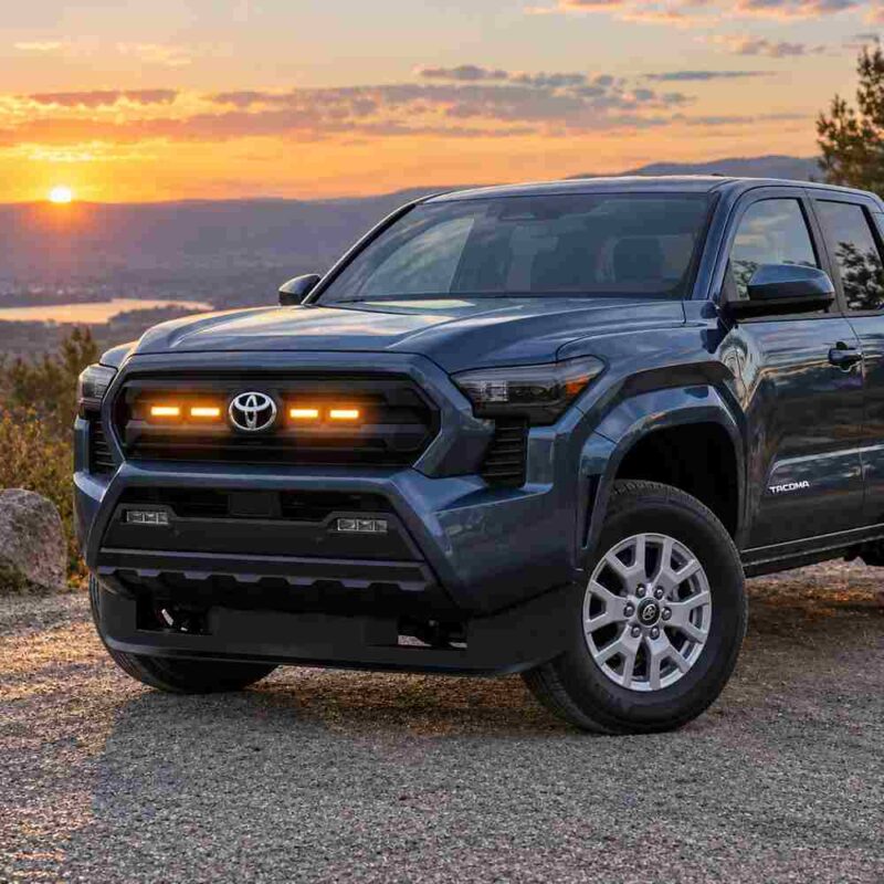 2024-2026 Toyota Tacoma with amber LED grille raptor lights at sunset outdoor scene