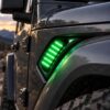Green RGB Jeep fender lights shown in a close-up vent installation