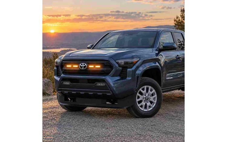 Toyota Tacoma with amber grill lights and raptor lights installed on the front grille