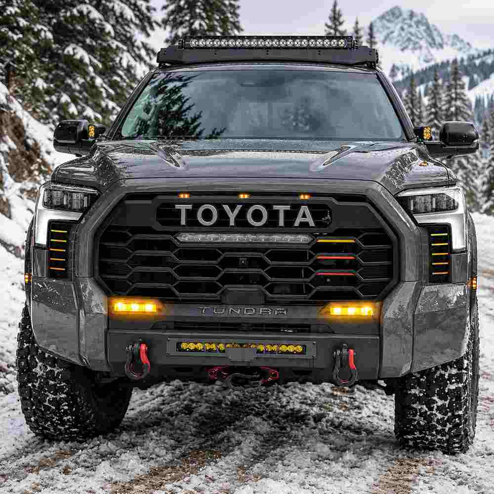 Toyota Tundra fog lamps illuminated amber on off-road truck in snowy winter conditions