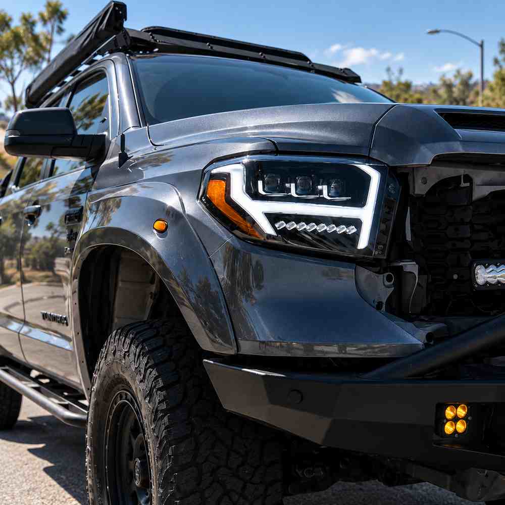 Toyota Tundra LED headlights installed on truck showing white DRL and triple projector design