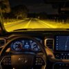 Driver view of a dark road illuminated by auxiliary lighting from a Toyota Tundra
